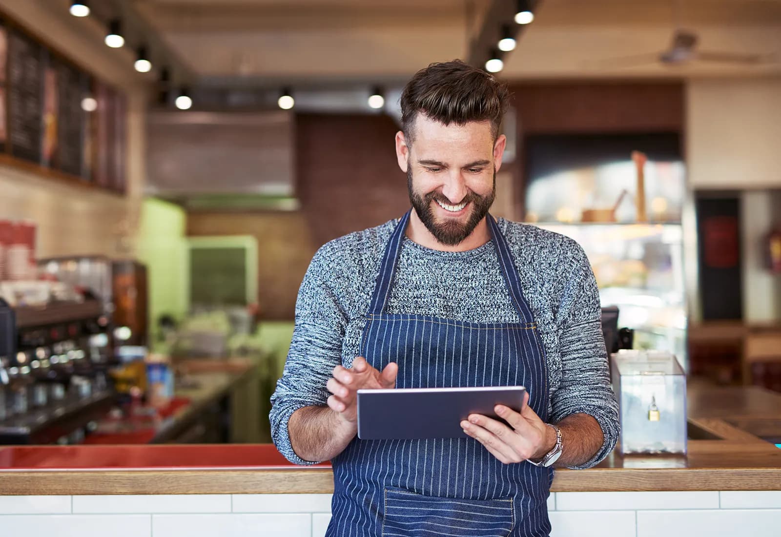 Happy Waiter using Tab