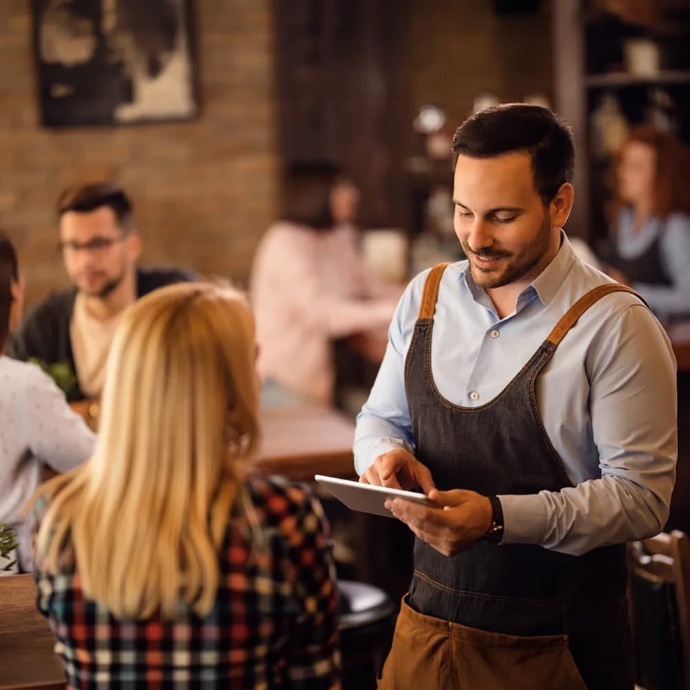 Waiter taking order in a cafe