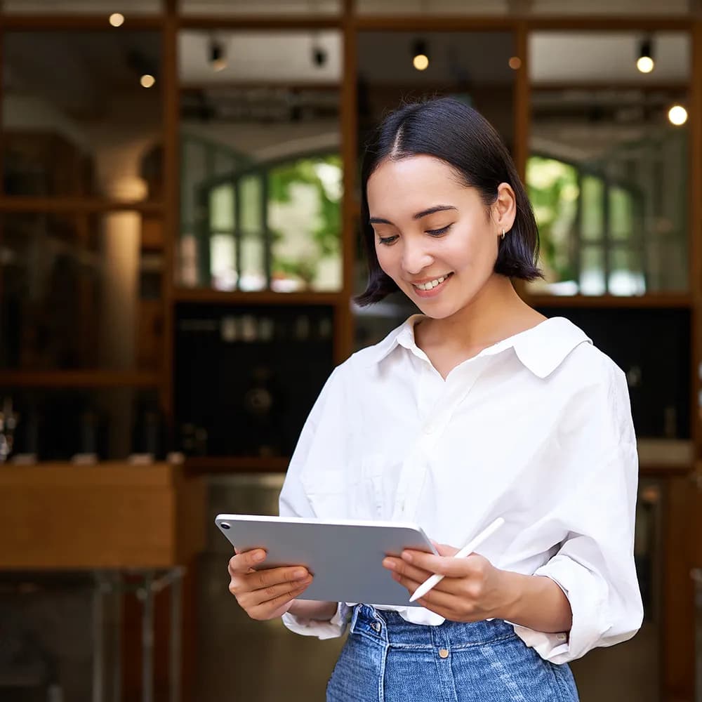 Woman working on tab.