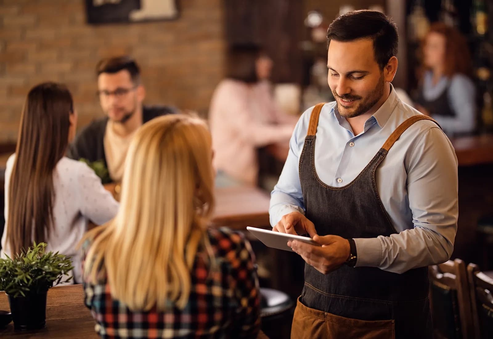 Waiter checking data of customer