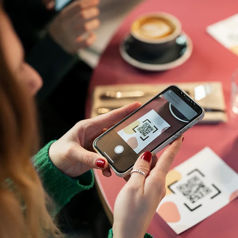 Woman scanning qr to order coffee