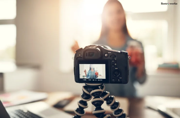 A women shooting herself on a video camera