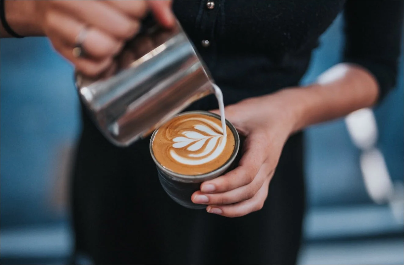 A barista creating coffee art.