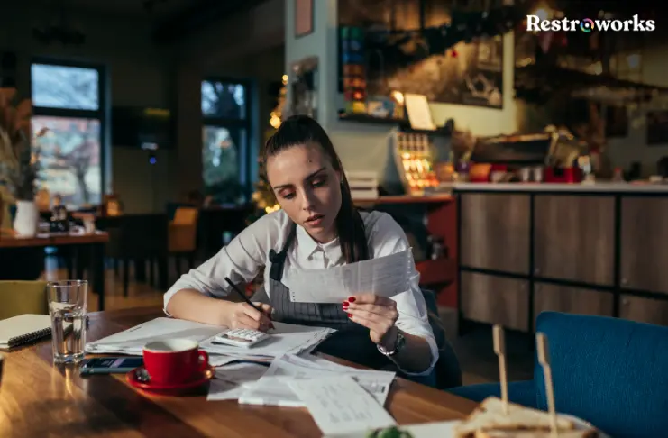 A restaurant staff member managing finances.
