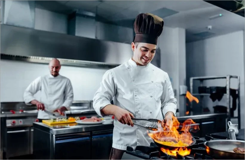 A chef in the kitchen cooking a special cuisine.